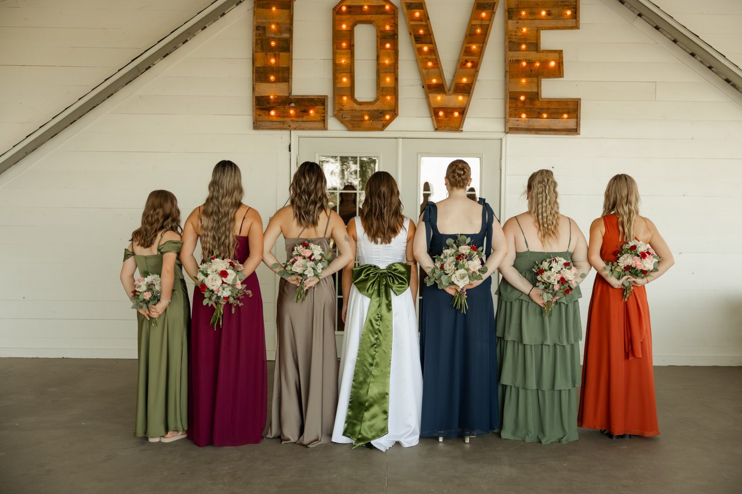 Matching bouquets for a bridal party in jewel-toned gowns