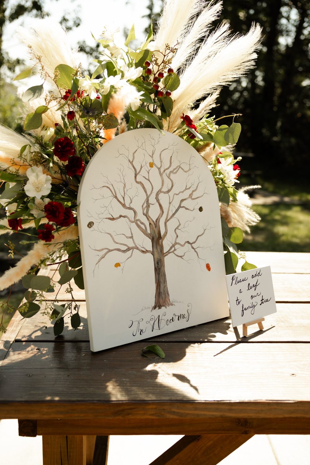 Pampas, alstroemeria and red carnations framing the guest book