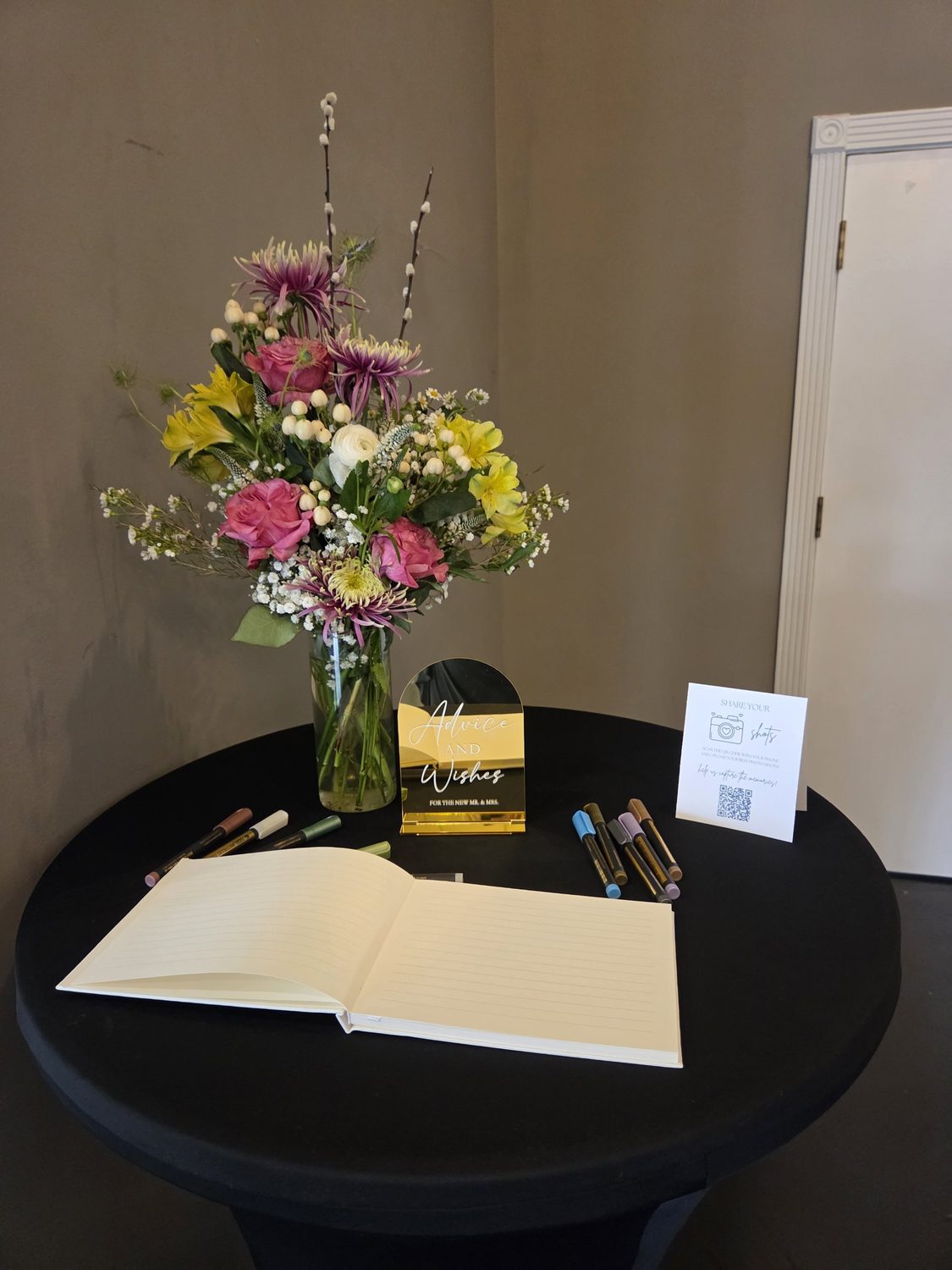 A guest book arrangement of roses, spider mums, alstroemeria and pussy willow