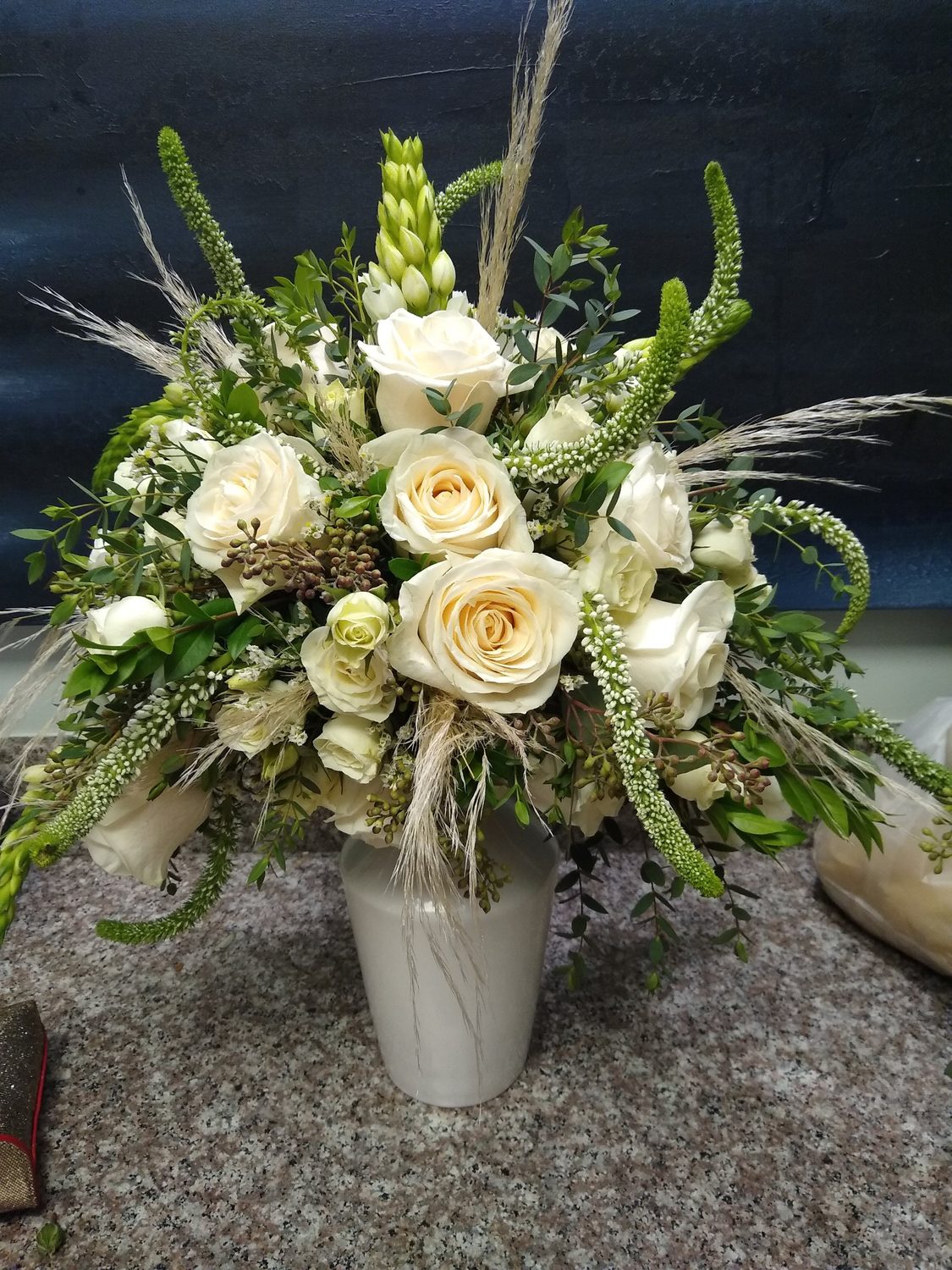 Ivory roses with veronica, star of Bethlehem and feathery grasses