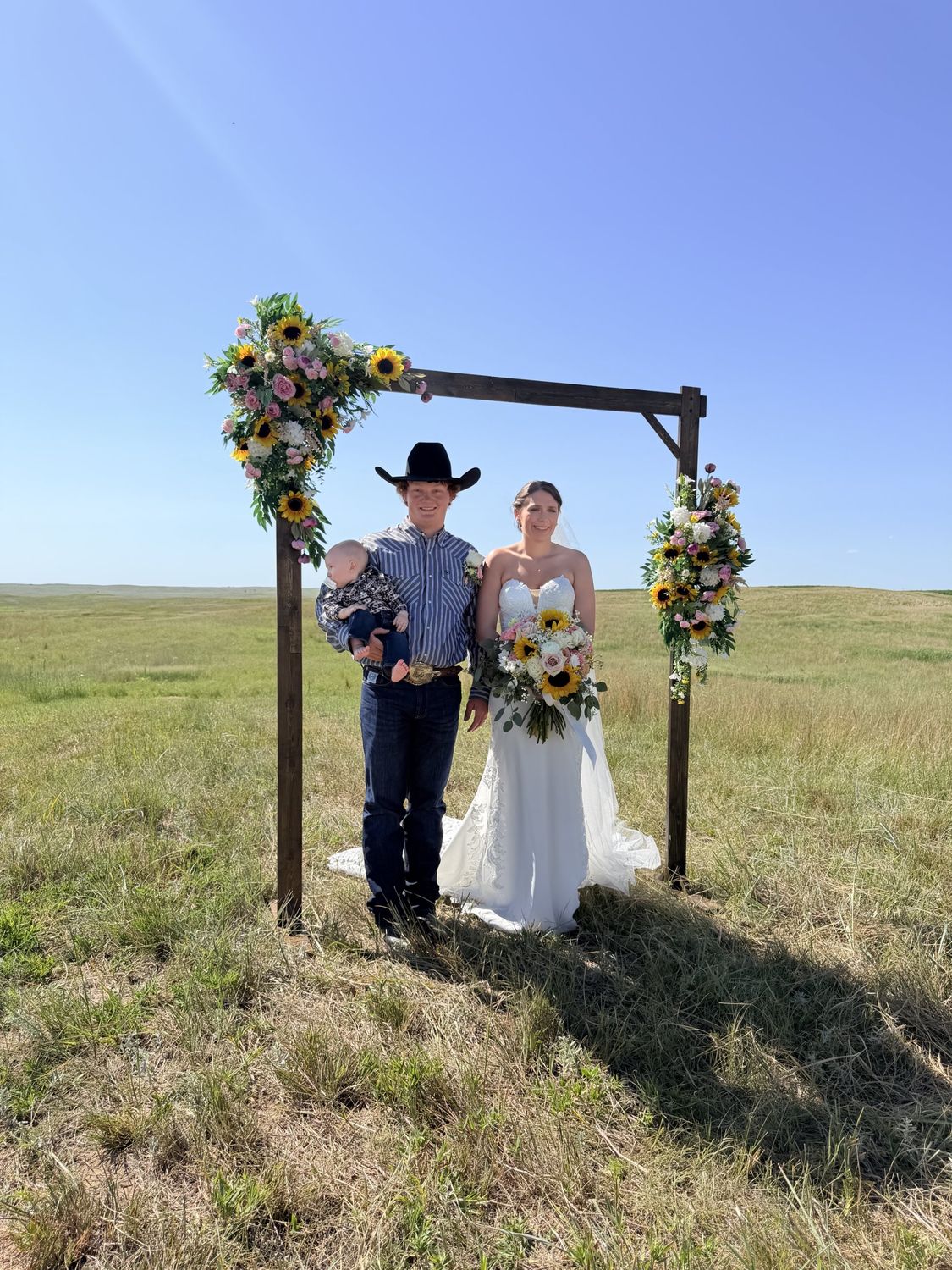 A sunflower ceremony arch on the open Nebraska prairie
