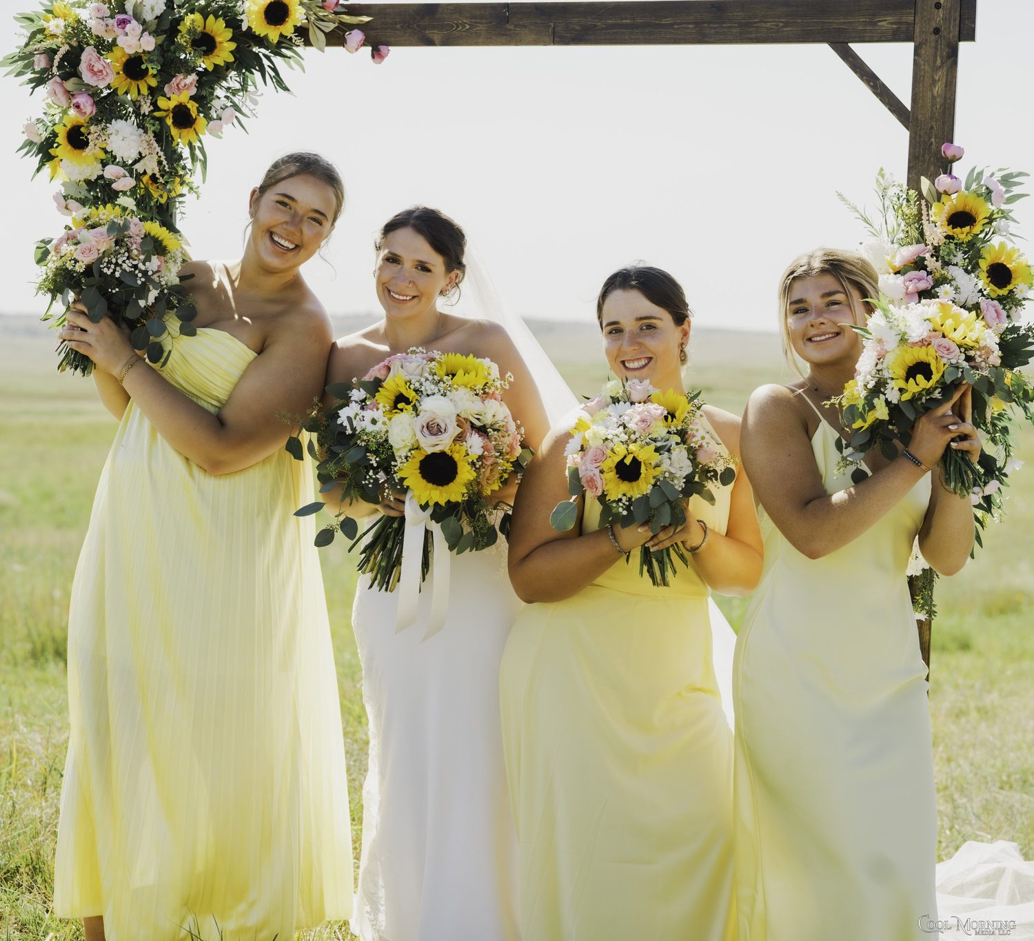 Sunflower and blush rose bouquets for the bride and her bridesmaids